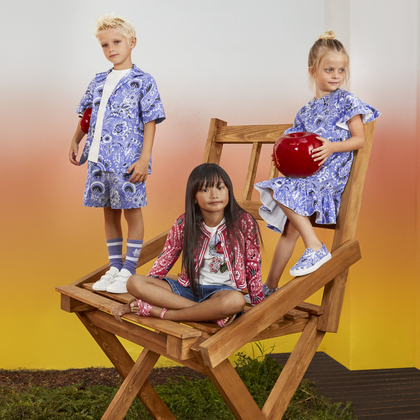 3 kids sitting an a chair and wearing ETRO kids collection