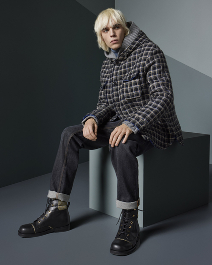 Model wearing Etro: a checkered jacket with a hood, dark cuffed jeans, and black lace-up boots.