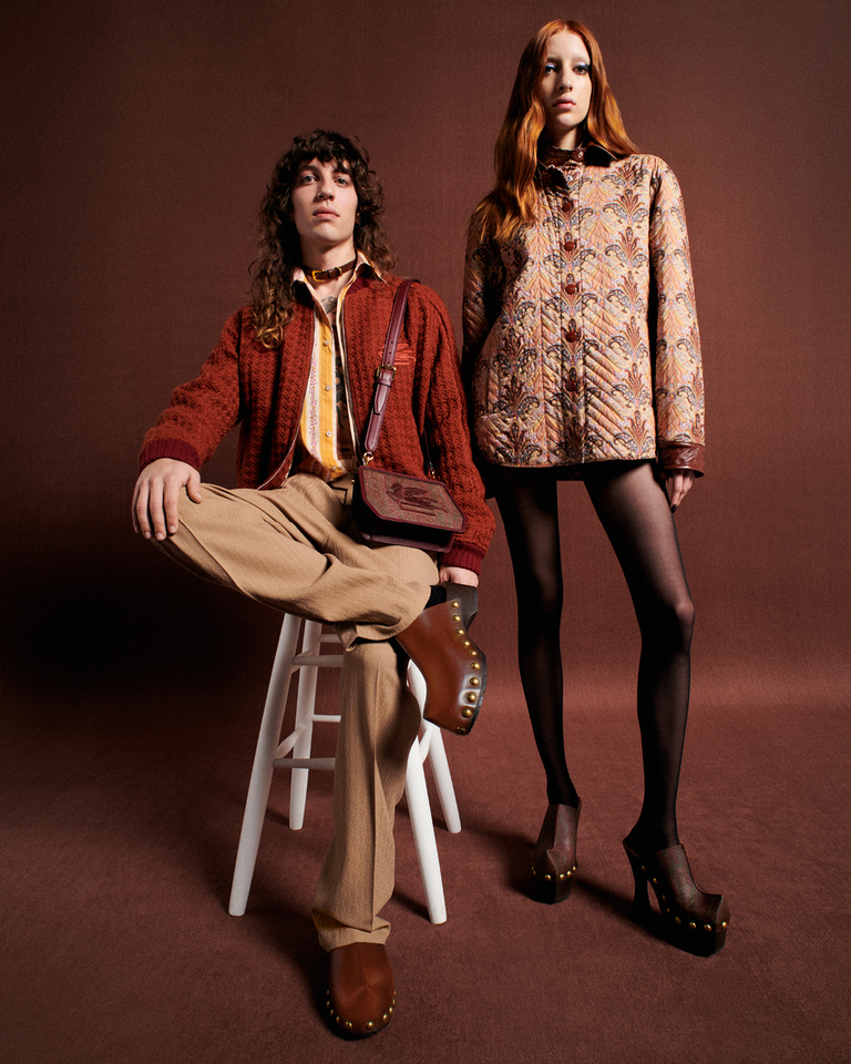 Boy- wearing. cardigan- trousers- clogs-and-bag-ETRO-Essential-with-Pegasus-ricamat-and-girl-with-jacket-Paisley-medallion.