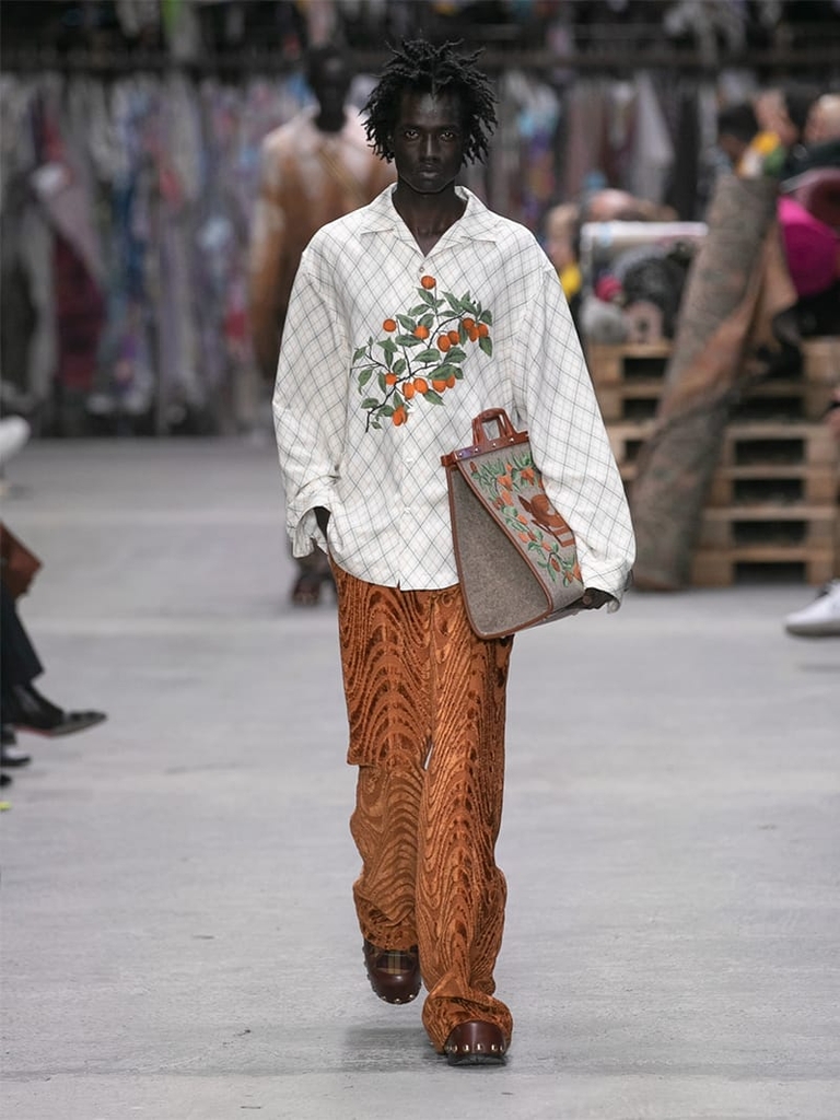 Model with white floral patterned shirt and orange trousers Etro fashion show fall winter collection 2023/2024