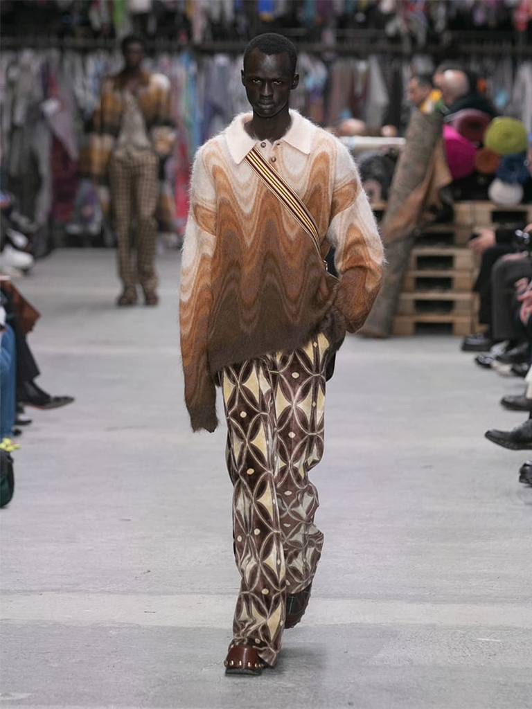 Model with multicoloured jumper and geometric motif trousers Etro fashion show fall winter collection 2023/2024