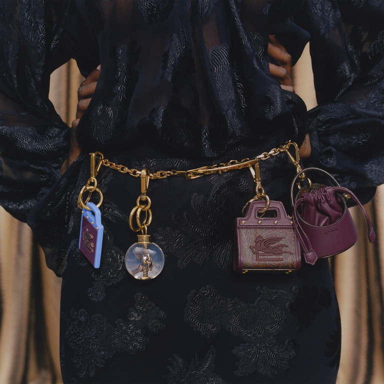 Detail of collection belt worn with applied collection charms including: Love Trotter i leather charm, mini purple Saturno and sphere with Pegaso.