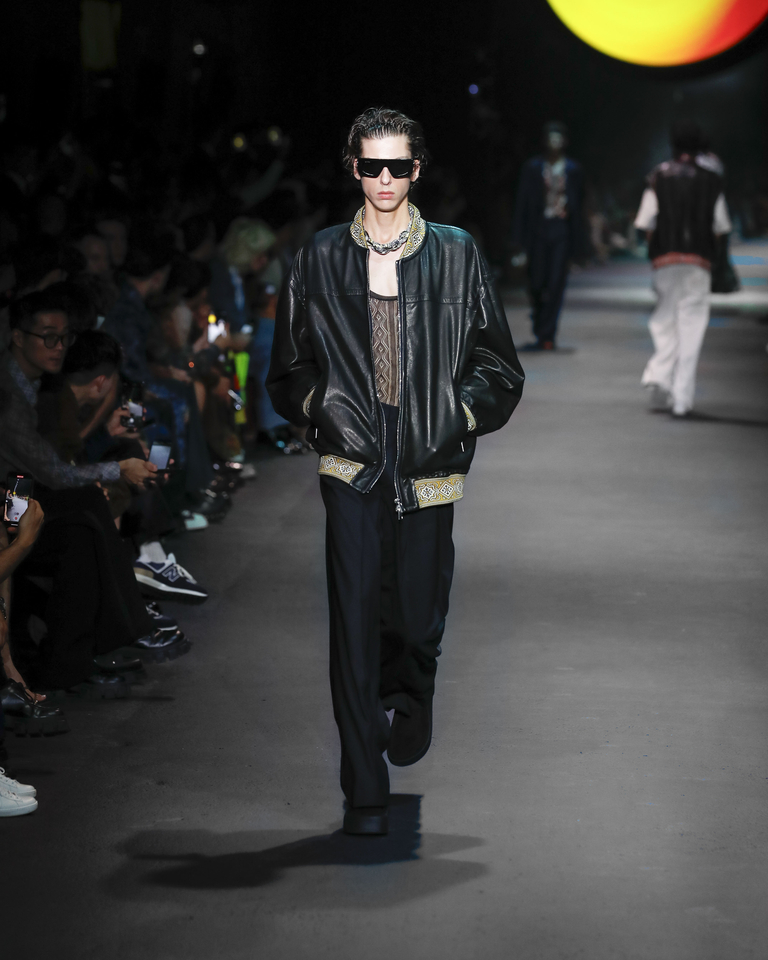 Model with sunglasses, black leather jacket, tank top and black trousers Etro Spring Summer collection 2024 fashion show