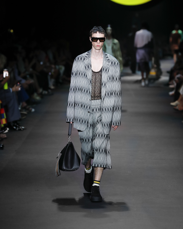 Model with sunglasses, suit with short shorts, black transparent tank top and black handbag Etro Spring Summer collection 2024 fashion show