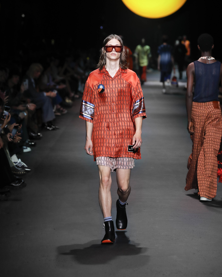 Model with sunglasses, orange short-sleeved shirt and short shorts Etro Spring Summer collection 2024 fashion show