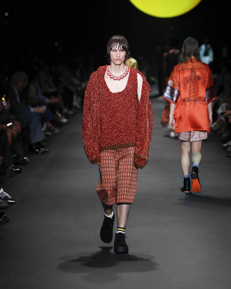 Model with necklace, orange sweatshirt, orange tank top and orange short trousers Etro Spring Summer collection 2024 fashion show